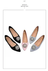 Detail of suede flat shoes with sparkling crystal snowflake buckles in black pink and grey