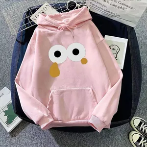 Detail of pink hoodie with cartoon eye graphic and kangaroo pocket in casual setting