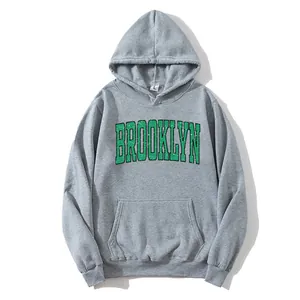 Women's light grey oversized hoodie with green Brooklyn print and front pouch pocket