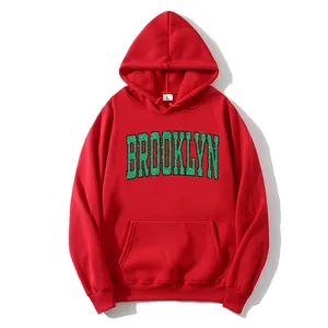 Red oversized hoodie for women featuring a distressed green Brooklyn print and a pocket