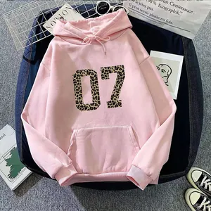 Flat lay of pink hoodie featuring leopard print number 07 and street style accessories