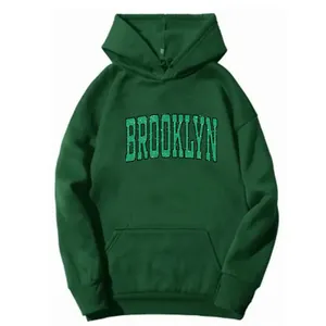 Detail of Brooklyn print on dark green oversized hoodie with a front kangaroo pocket