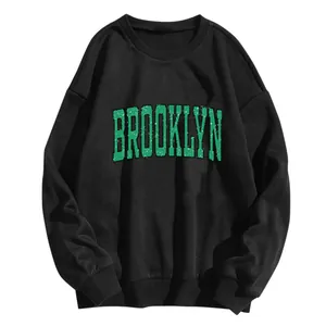 Loose black crewneck sweatshirt with vintage green Brooklyn letter print and ribbed cuffs
