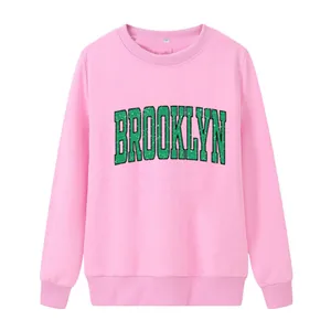 Pink crewneck sweatshirt with green BROOKLYN print, loose fit long sleeve for women