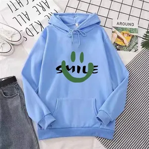 Light blue hoodie with Smile graphic and kangaroo pocket in a casual flat lay set