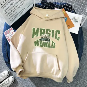 Detail of oversized beige hoodie with green Magic World print and kangaroo pocket