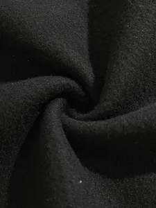 Gros plan sur le tissu polaire noir montrant la texture douce et l'épaisseur du coton