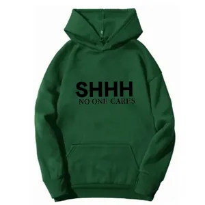 Detail of dark green hoodie featuring SHHH NO ONE CARES print and ribbed cuffs