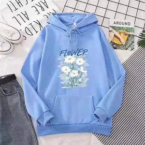Detailed flat lay of light blue hoodie featuring daisy embroidery and flower lettering