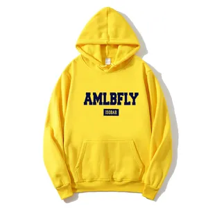 Detailed view of yellow hoodie featuring navy AMLBFLY print and classic kangaroo pocket