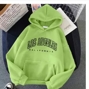 Detailed view of neon green oversized hoodie featuring Los Angeles printed text and pocket
