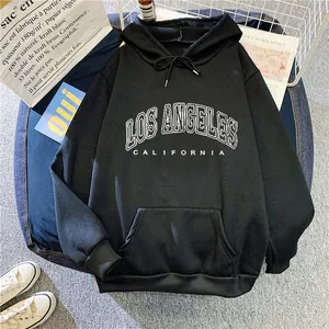 Detail of loose black hoodie featuring white Los Angeles California printed lettering