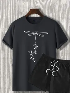 Detail of black summer set showing white dragonfly print on T-shirt and drawstring shorts