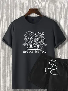 Detail view of dark grey T-shirt with cartoon earth print and black drawstring shorts