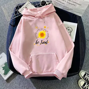 Detail view of pink fleece hoodie with sunflower print and Be Kind motivational text