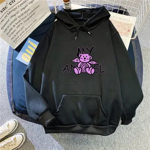 Detail of black hoodie featuring purple angel bear graphic and large front pocket