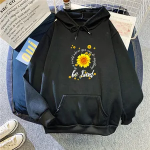 Detail of sunflower print and be kind slogan on a black fleece hoodie with pocket
