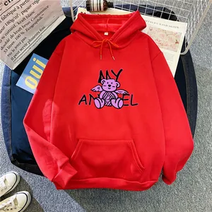 Detail of red oversized hoodie featuring angel bear graphic and kangaroo pocket