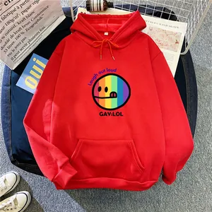 Flat lay of a red oversized hoodie with a rainbow smiley face and kangaroo pocket