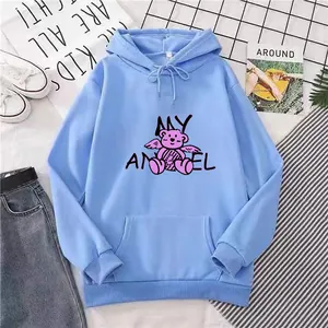 Flatlay of sky blue oversized hoodie featuring pink angel bear print and kangaroo pocket