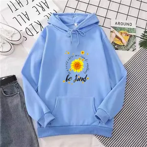 Close-up of light blue hoodie featuring sunflower print and kangaroo pocket detail