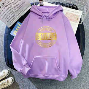 Detail of purple oversized hoodie with gold circular graphic print and kangaroo pocket