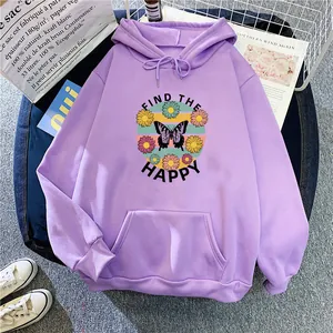 Detail of lavender hoodie featuring a butterfly and daisy print with happy slogan