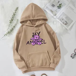Detail of khaki oversized hoodie featuring a pink angel bear print and a kangaroo pocket