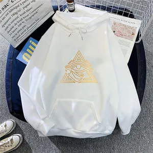 Flat lay of white oversized hoodie with golden Eye of Horus graphic and kangaroo pocket