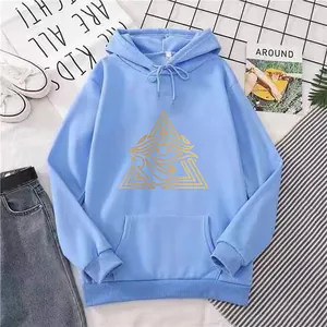 Detailed flat lay of light blue hoodie with yellow triangle eye print and casual props