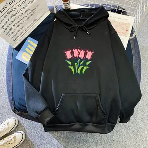 Close-up of pink tulip graphic print on black cotton blend hoodie with kangaroo pocket