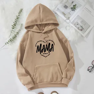 Detail of khaki oversized hoodie with MAMA heart print on soft plush background