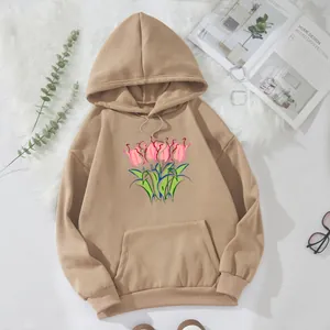 Detailed close-up of khaki hooded sweatshirt with tulip print and kangaroo pocket