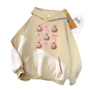 Oversized beige hoodie with pink bows and watercolor Halloween pumpkin graphic design