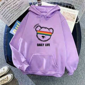 Detailed view of light purple hoodie with cartoon bear and rainbow lettering