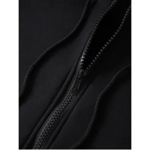Close-up of black metal zipper and dense knit fabric texture on hooded sweatshirt
