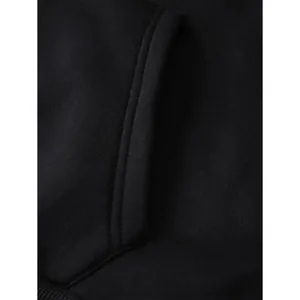 Detailed macro view of the hoodie pockets and ribbed hem showing high-quality cotton texture