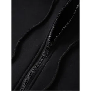 Close-up of black oversized hoodie featuring high-quality zipper and drawstring details