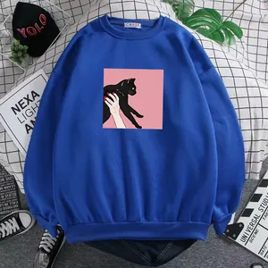 Detail of blue crewneck sweatshirt featuring a black cat art print and ribbed cuffs