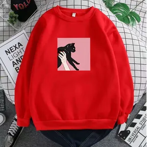 Detailed close-up of a red crewneck sweatshirt featuring a black cat illustration print
