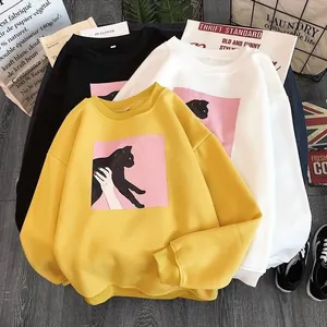 Loose crewneck sweatshirt with black cat silhouette print in yellow, black, and white