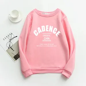 Flat lay of pink letter print crewneck sweatshirt with glasses and magazine