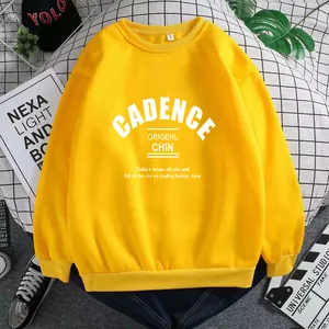 Detail of yellow sweatshirt featuring white letter print and ribbed cuffs in a flat lay style
