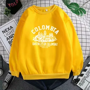 Detail view of yellow crewneck sweatshirt with ribbed cuffs and white urban print