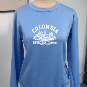 Close-up of the vintage Columbia print and white graphic on the blue crewneck sweatshirt