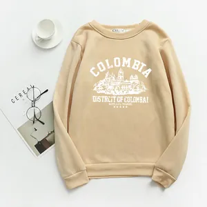 Detailed flat lay of beige crewneck sweatshirt with retro Colombia print and ribbed cuffs
