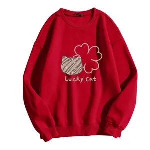 Detail of red crewneck sweatshirt featuring a Lucky Cat print and ribbed cuffs