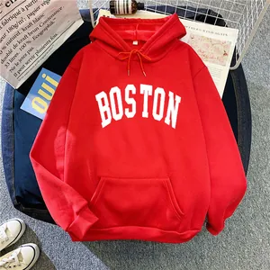 Detail of red hoodie with white BOSTON lettering, drawstring hood and kangaroo pocket