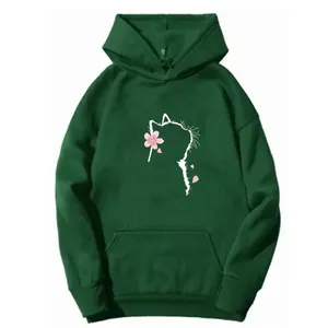 Detailed close-up of dark green hoodie featuring a white cat and pink cherry blossom print