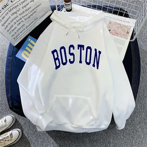 Detail of white hooded sweatshirt featuring blue Boston lettering and kangaroo pocket